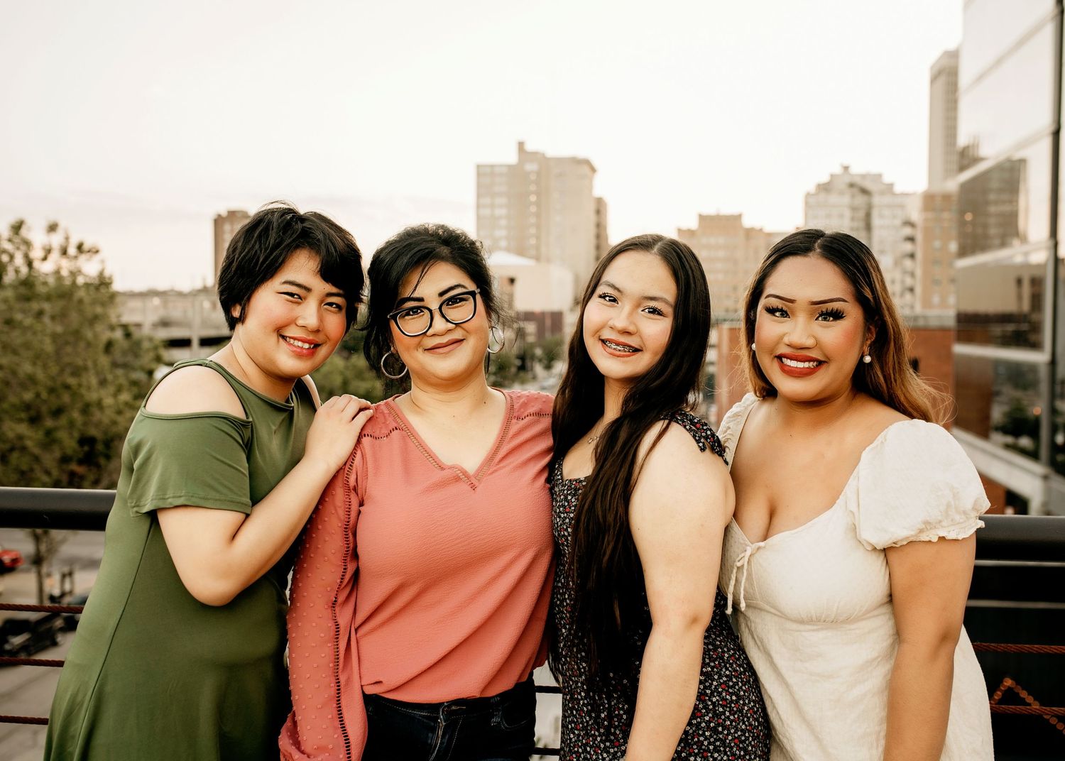 Mom and daughters posing on rooftop in downtown Omaha Nebraska