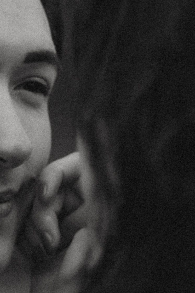 Black and white close-up portrait showing genuine emotion and connection.