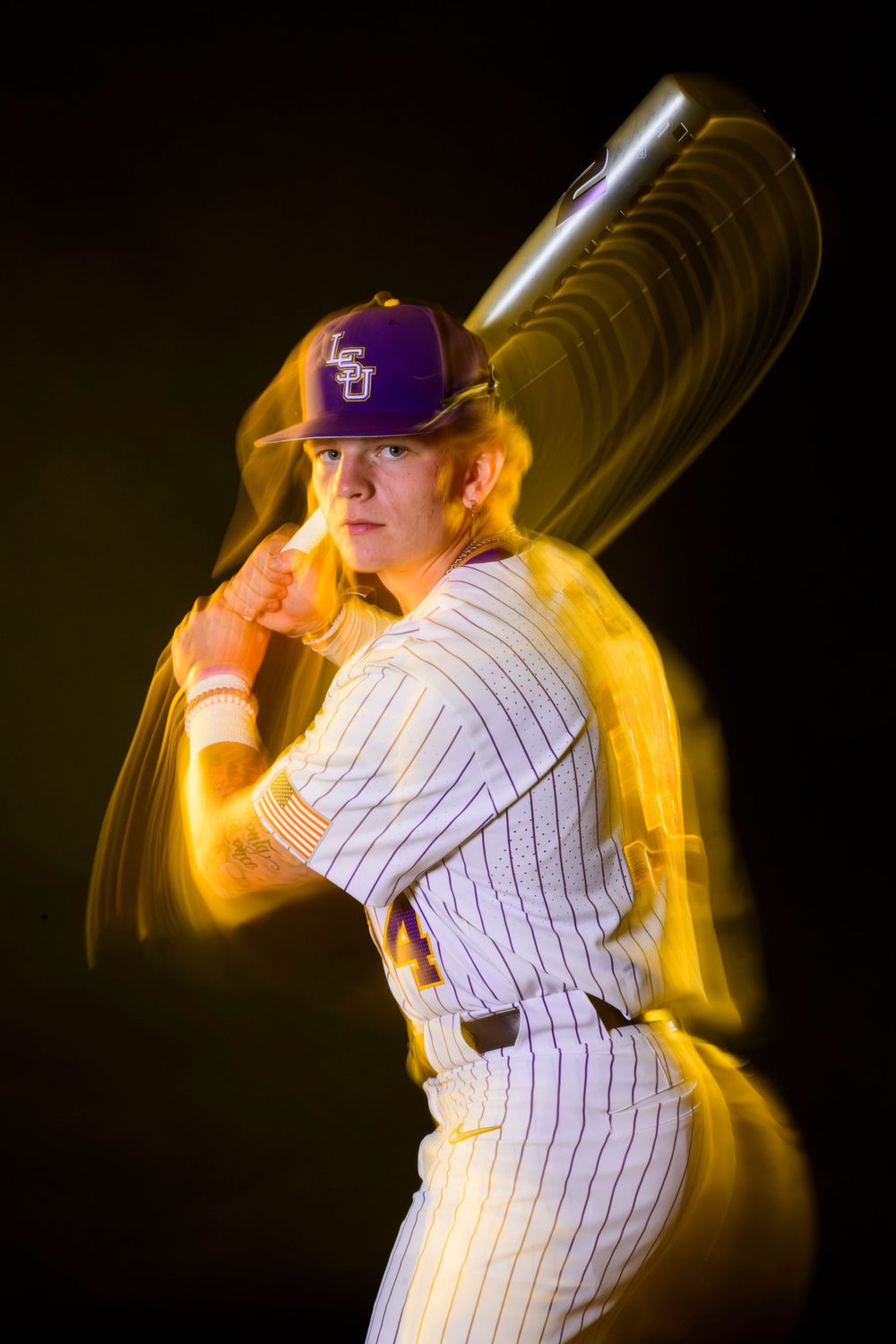 Baseball batter stance sequence showing follow-through motion in white pinstriped uniform.
