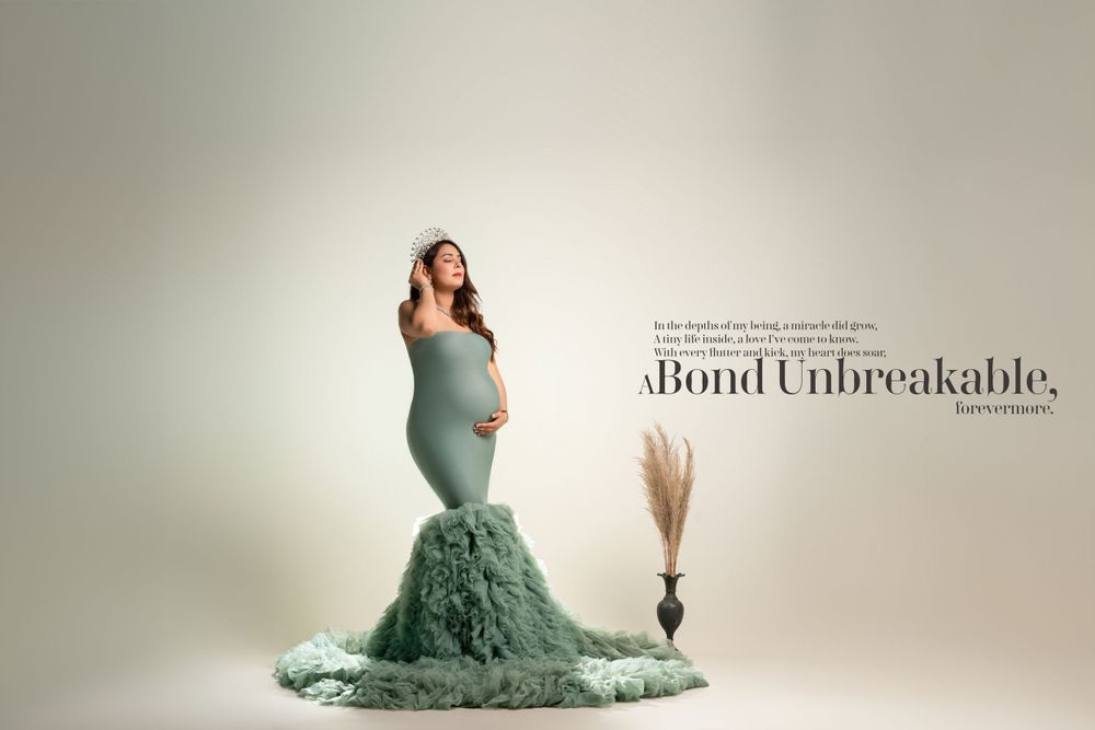 Dramatic maternity portrait in sage green gown with 'Bond Unbreakable' text overlay.