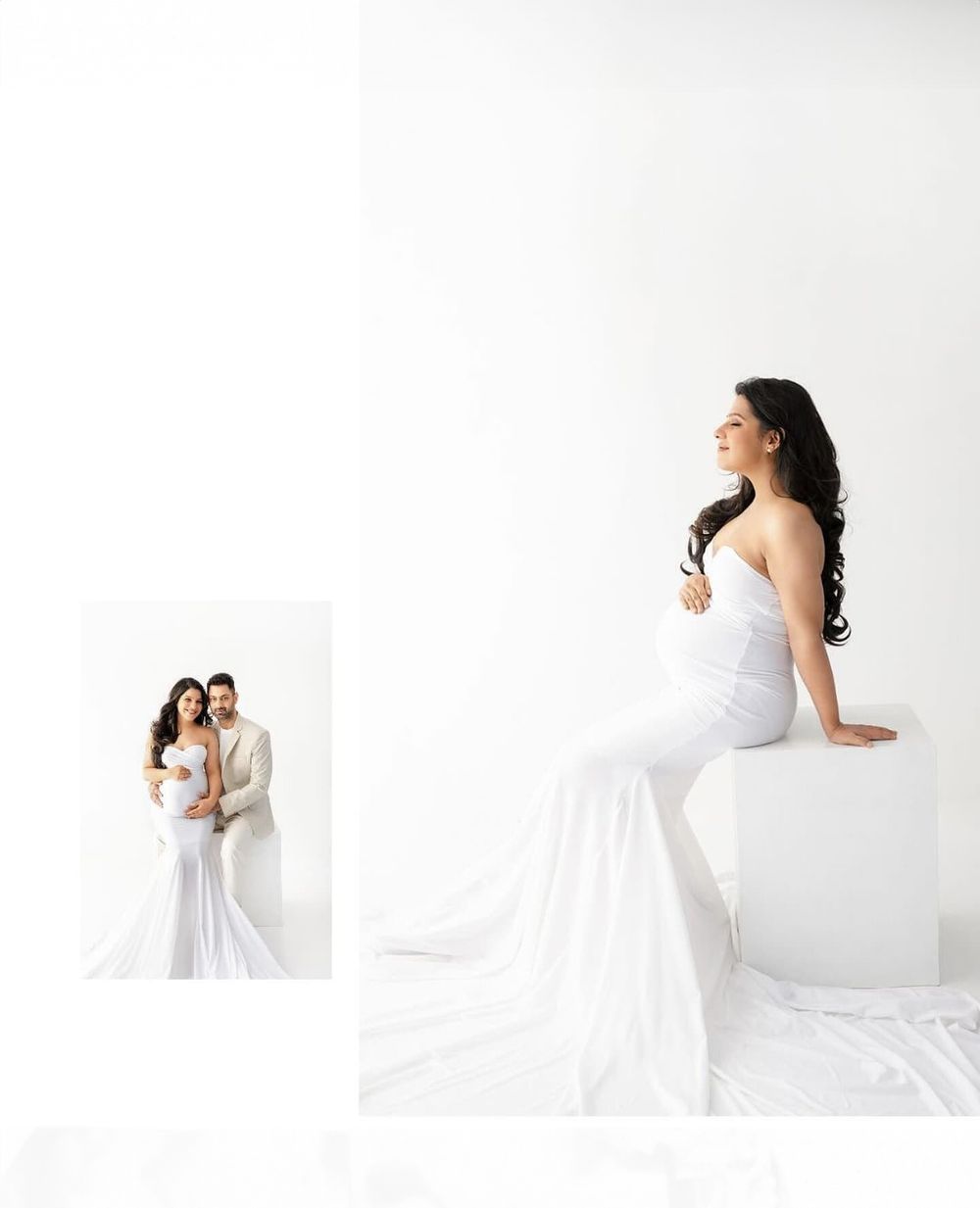 Modern maternity photography with white gown against minimalist backdrop and mirror reflection.