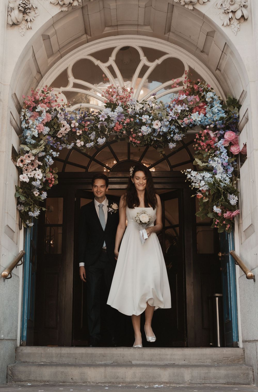 Bride and groom walking hand in hand at out of intimate Chelsea wedding captured by Shayla Bloom Photography