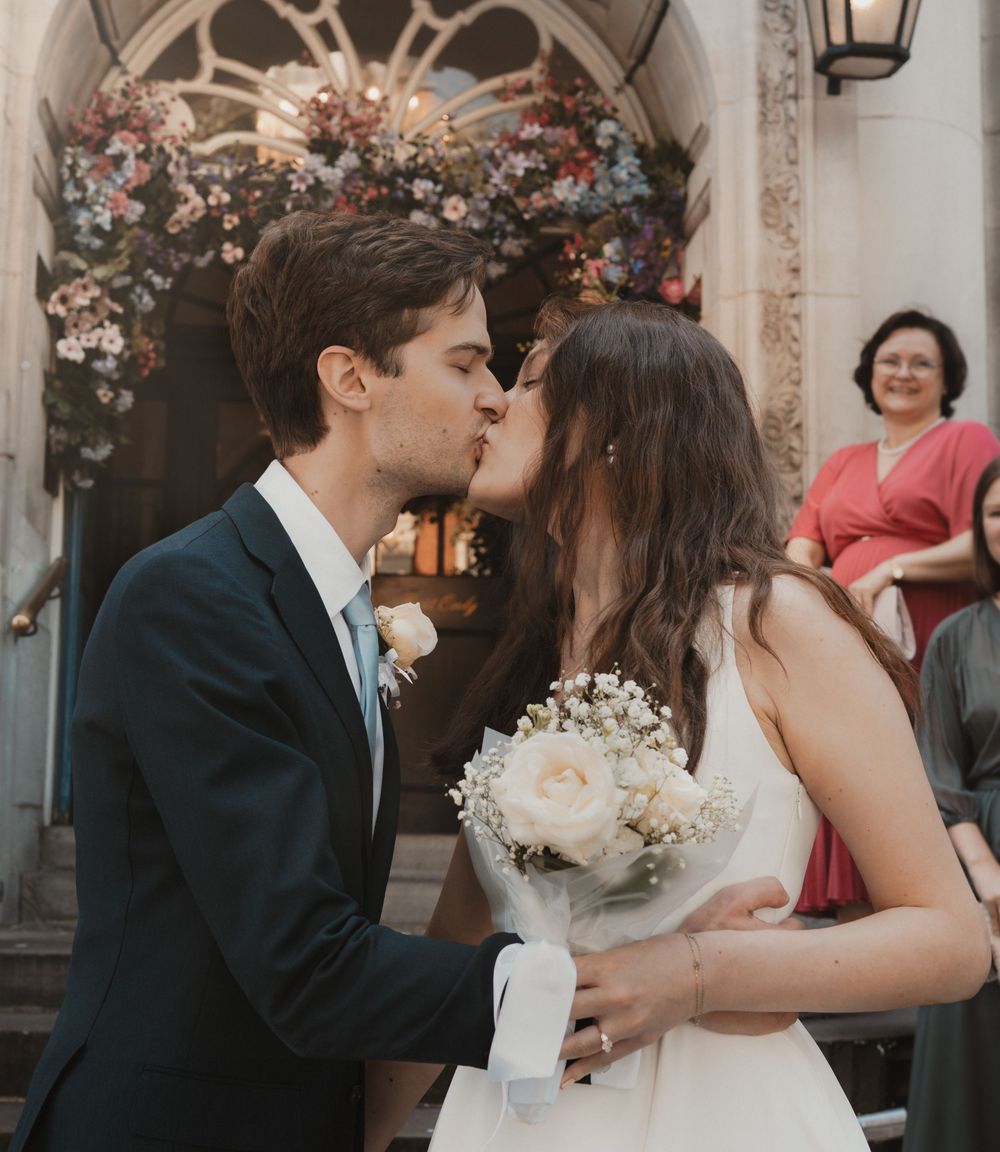 Bride and groom sharing a kiss at intimate Chelsea, London wedding by Shayla Bloom Photography