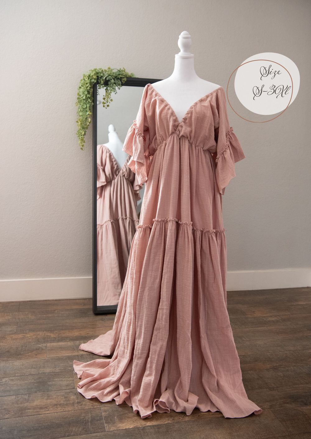 Dusty rose tiered maxi dress with flutter sleeves and empire waist displayed on white mannequin.