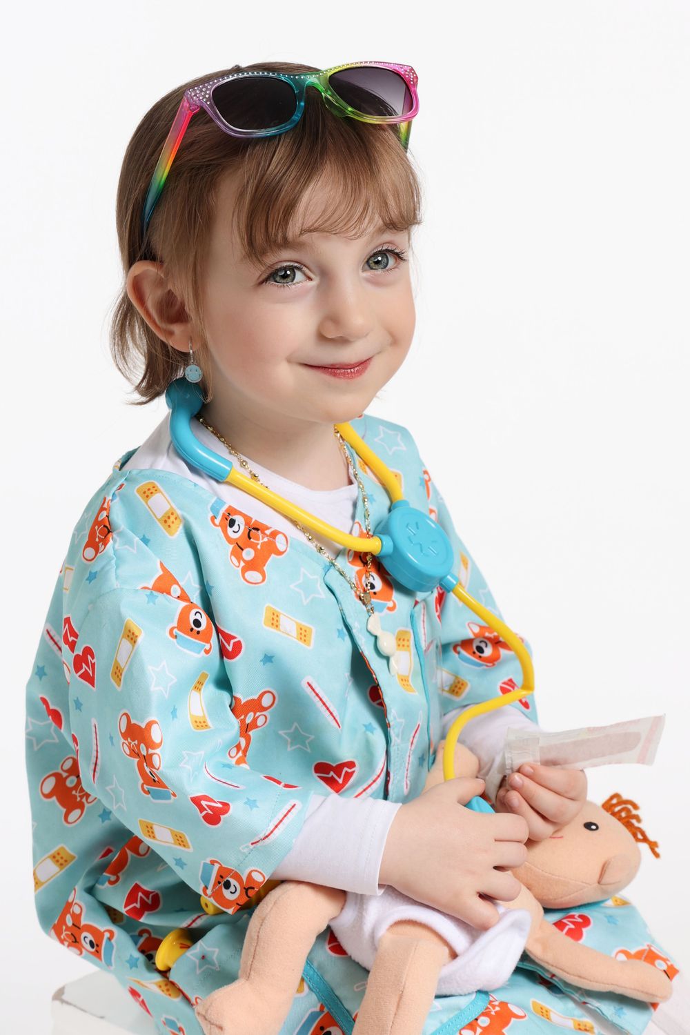 A colorful fox-print medical gown with rainbow sunglasses and blue stethoscope.