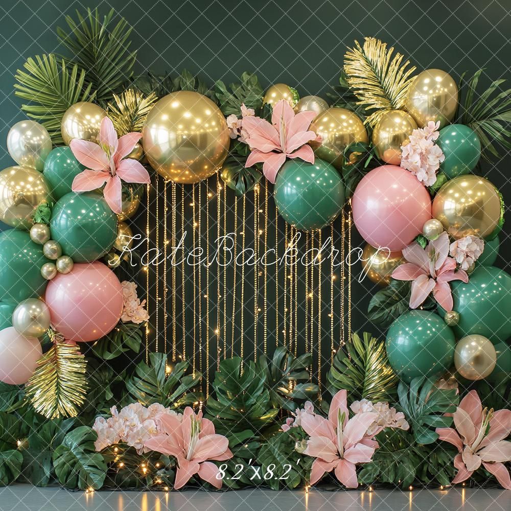 A luxurious event backdrop with gold and teal ornaments, pink lilies, and metallic panels creates an elegant party setting.