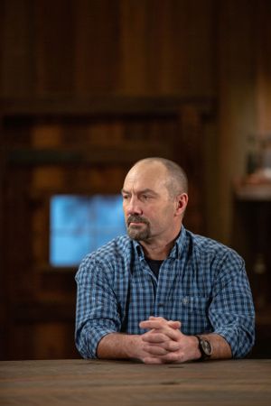 A man in a plaid shirt sits at a wooden table with clasped hands in a rustic setting.
Commercial Photography
Gold Rush