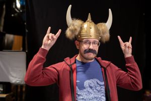Person wearing a Viking helmet and red jacket making rock gestures against black background.
Commercial Photography
Gold Rush