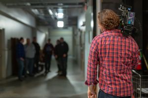 Camera operator filming in a hallway with people gathered in the background.
Commercial Photography
Gold Rush