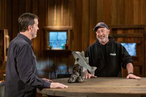 Two people examining a metal part across wooden table in rustic setting.
Commercial Photography
Gold Rush