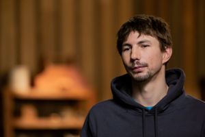Person wearing dark hoodie against wood paneled background in dim lighting.
Commercial Photography
Gold Rush