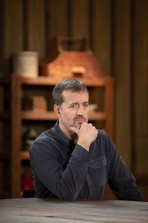 A thoughtful person in a dark shirt sits at wooden table with hand on chin.
Commercial Photography
Gold Rush
