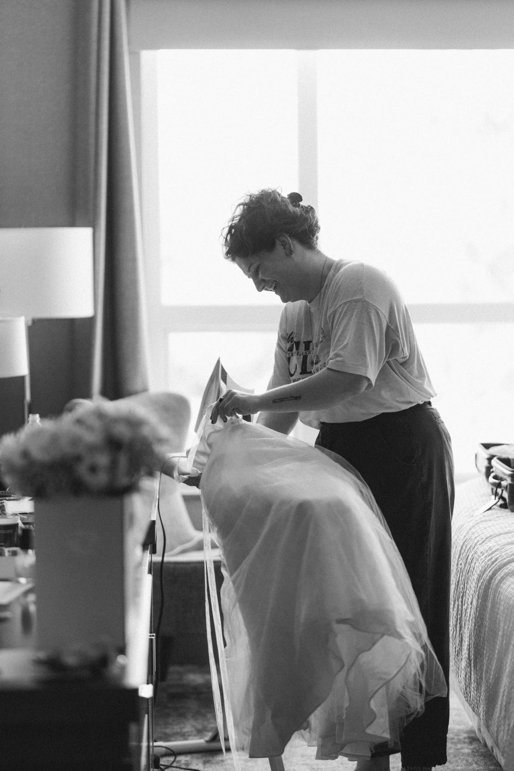Someone steams a white wedding dress in preparation for a special day.