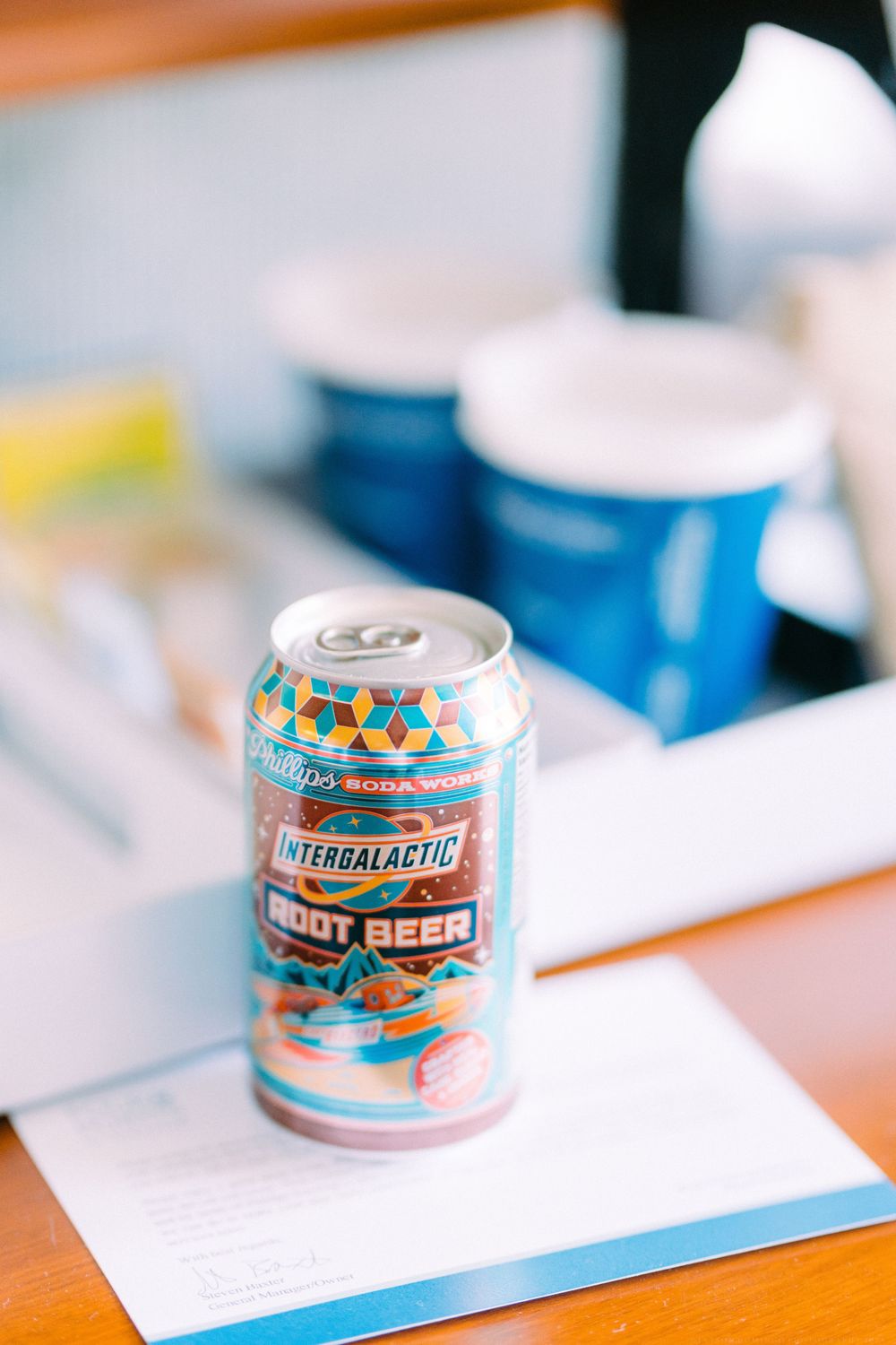 An Intergalactic brand root beer can sits on a white surface.