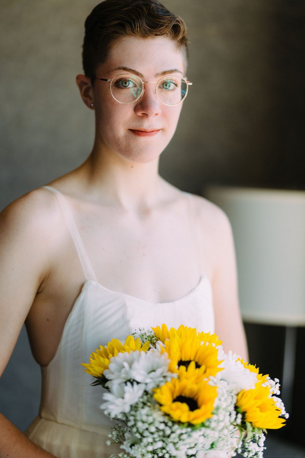 Portrait with sunflower bouquet featuring yellow blooms and baby's breath.