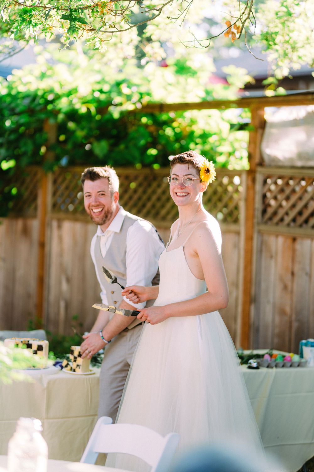 A joyful celebration moment at an outdoor garden wedding reception.