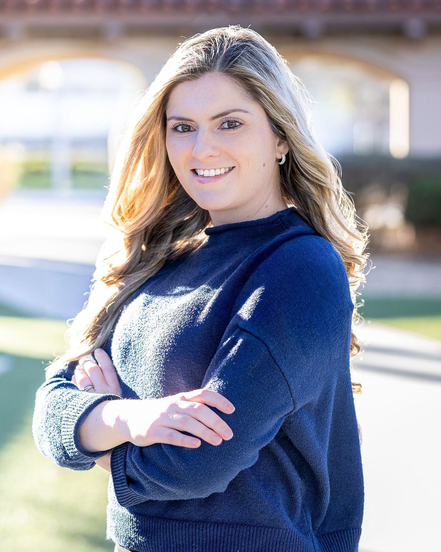 Professional headshot of a female outdoors using natural light. The model is posed for a lifestyle shoot.