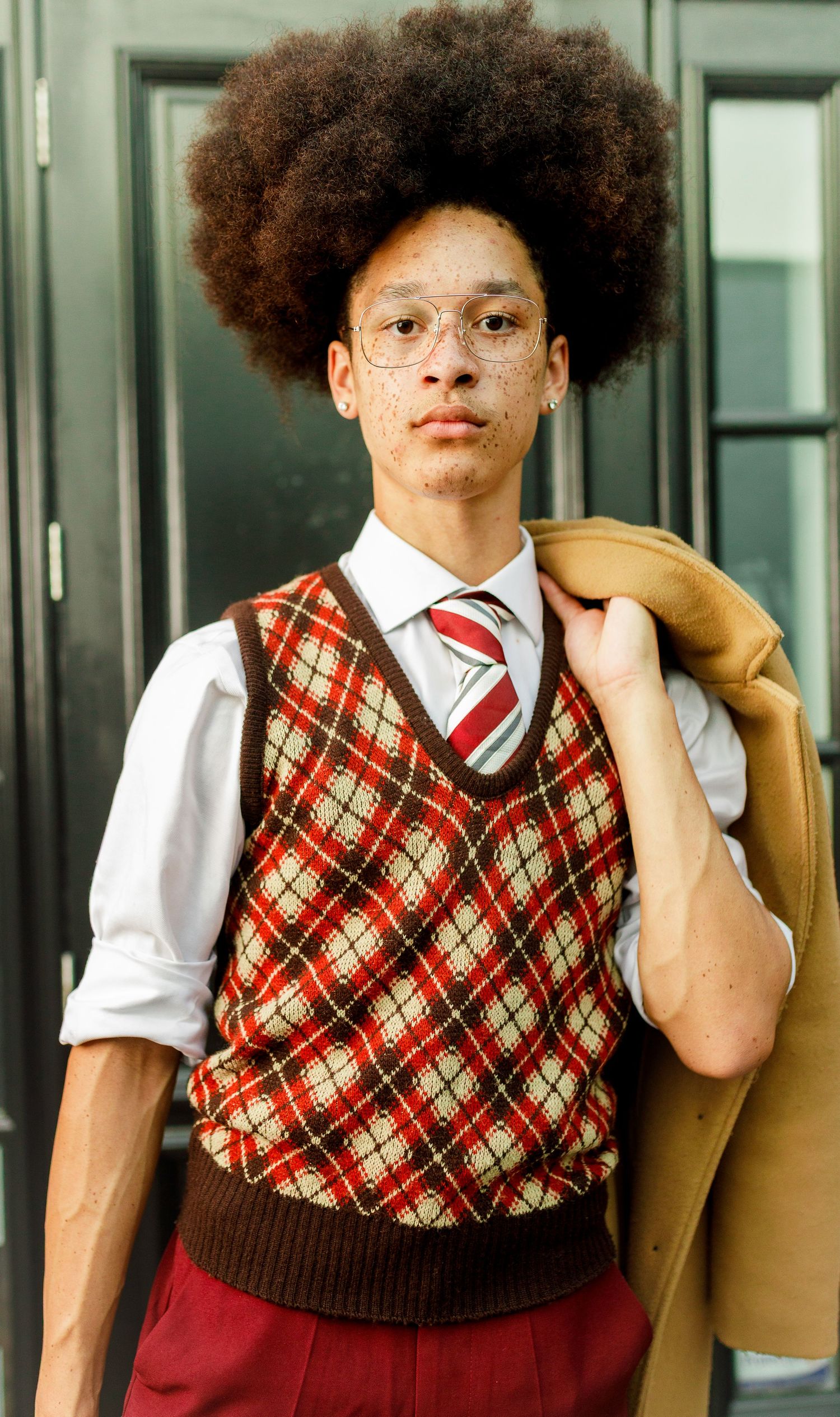 Jeremiah wearing matching argyle sweater vests and white shirt to show his versatility in style.