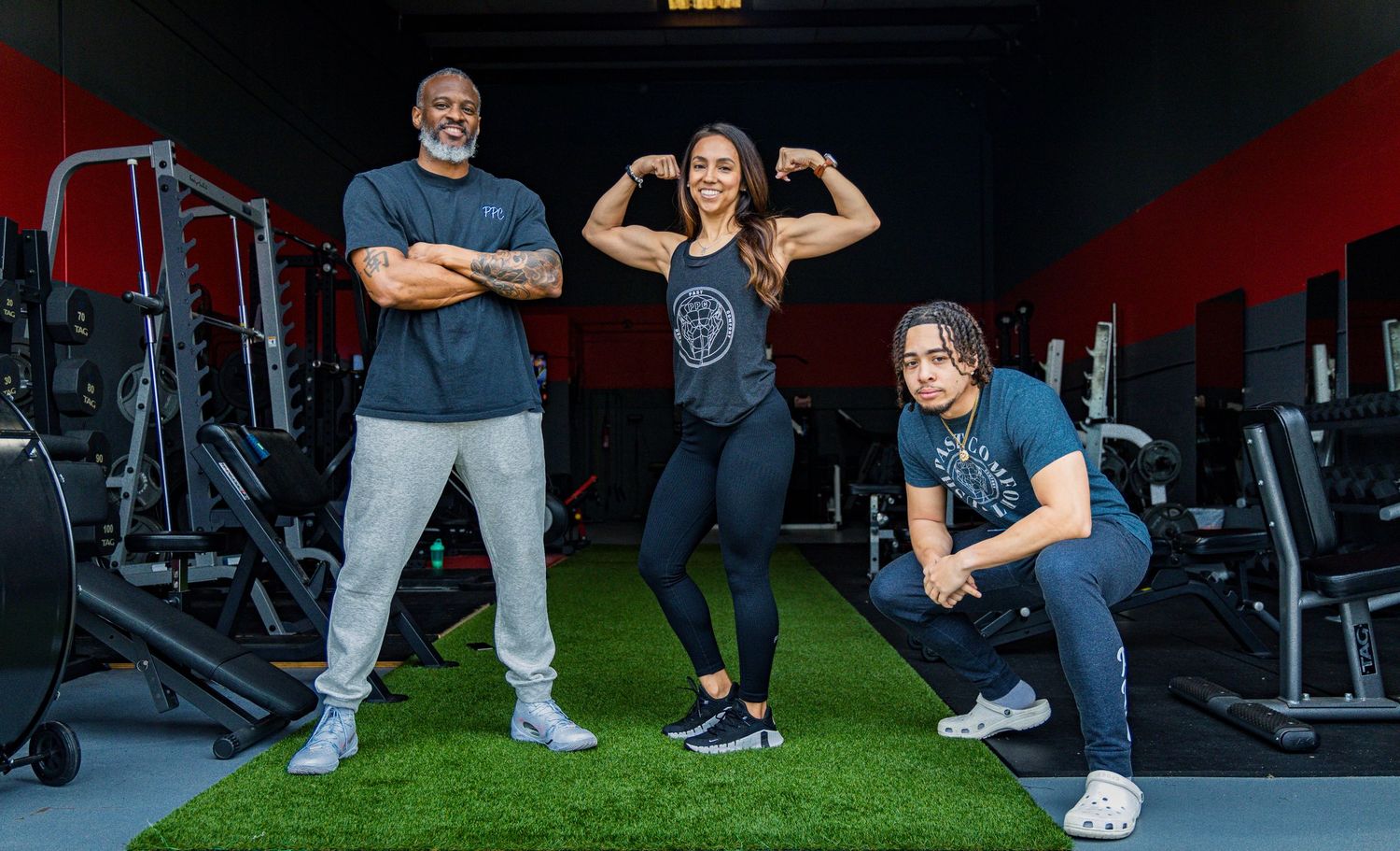 Group fitness shot in a modern gym setting with exercise equipment.