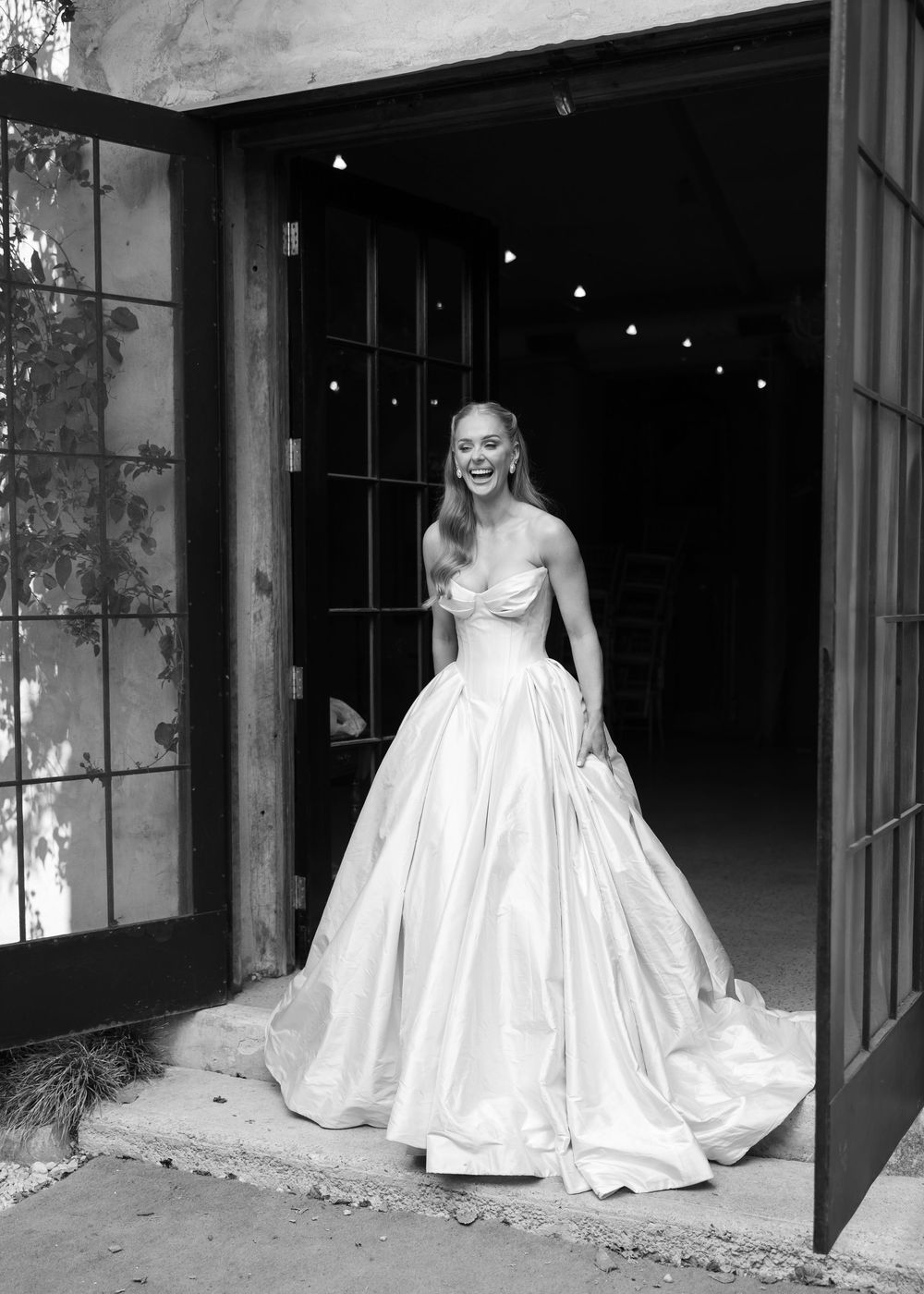 Dramatic bridal portraits in a white ballgown against industrial architectural backdrop in Adelaide Al Ru Farm