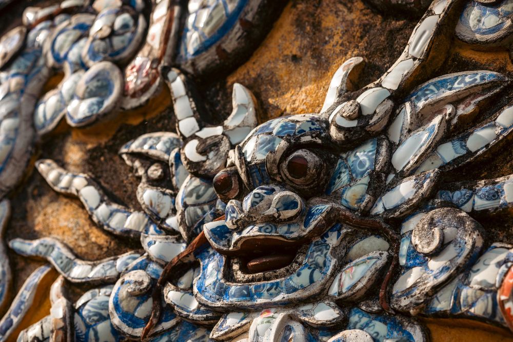 Ornate blue and white decorative dragon sculpture detail on traditional Asian temple architecture.