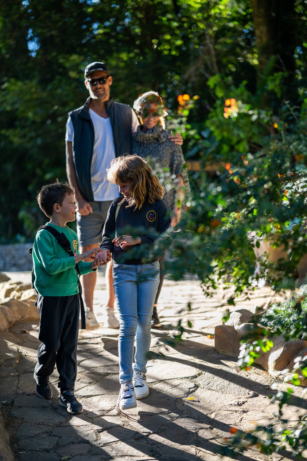 Family enjoying a nature walk together on a sunny afternoon in the woods.