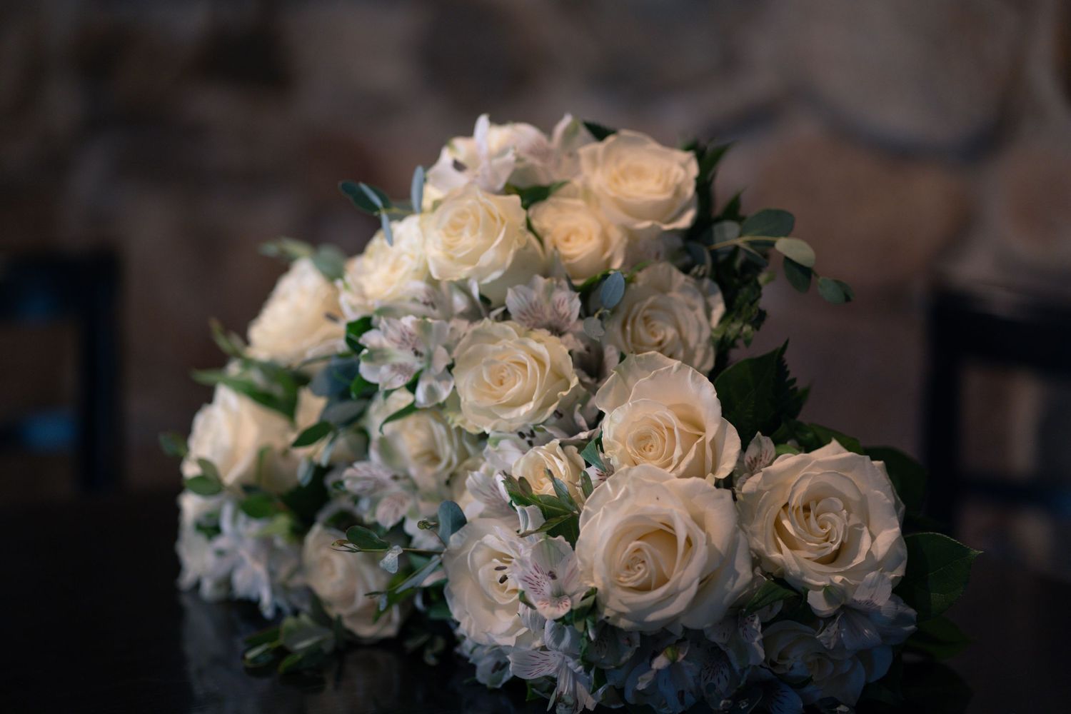 A close up portrait of a bouquet of white roses at the wedding reception