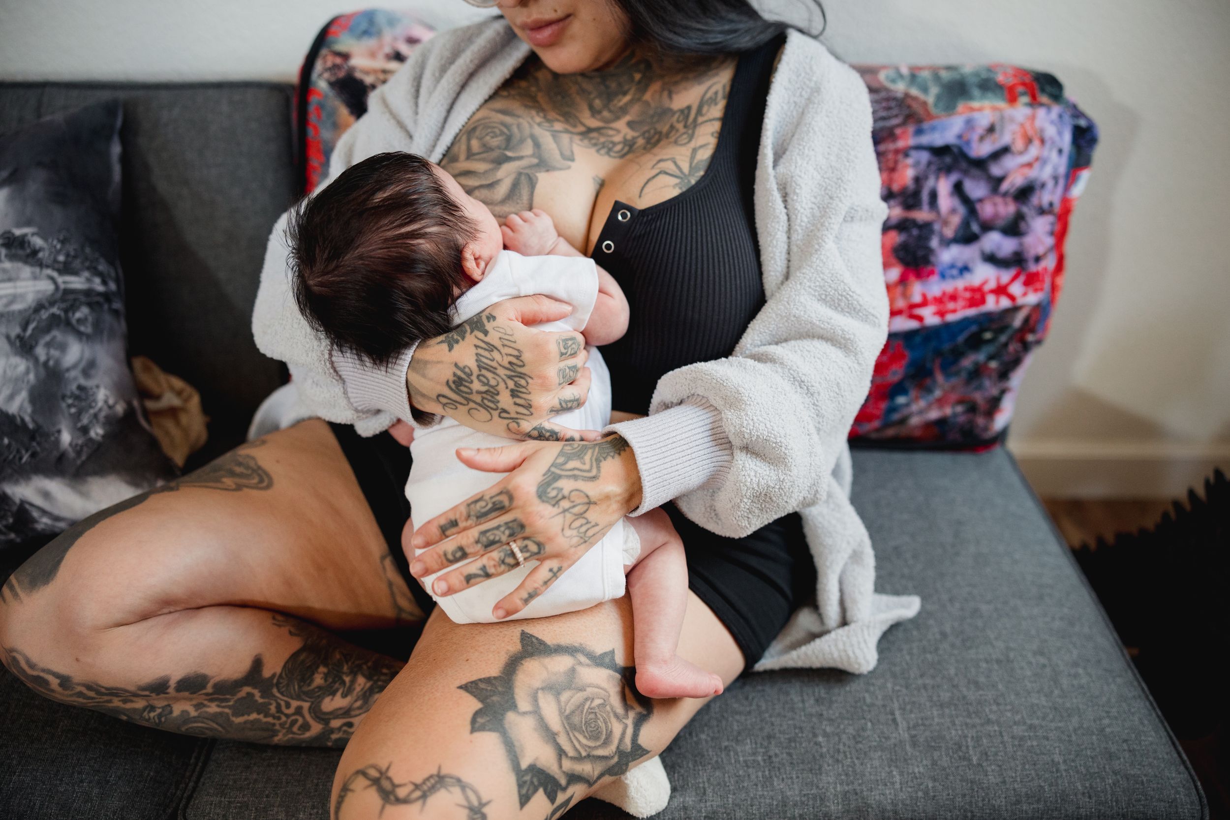 A series of photos showing a baby being cradled and held while wearing a white onesie.