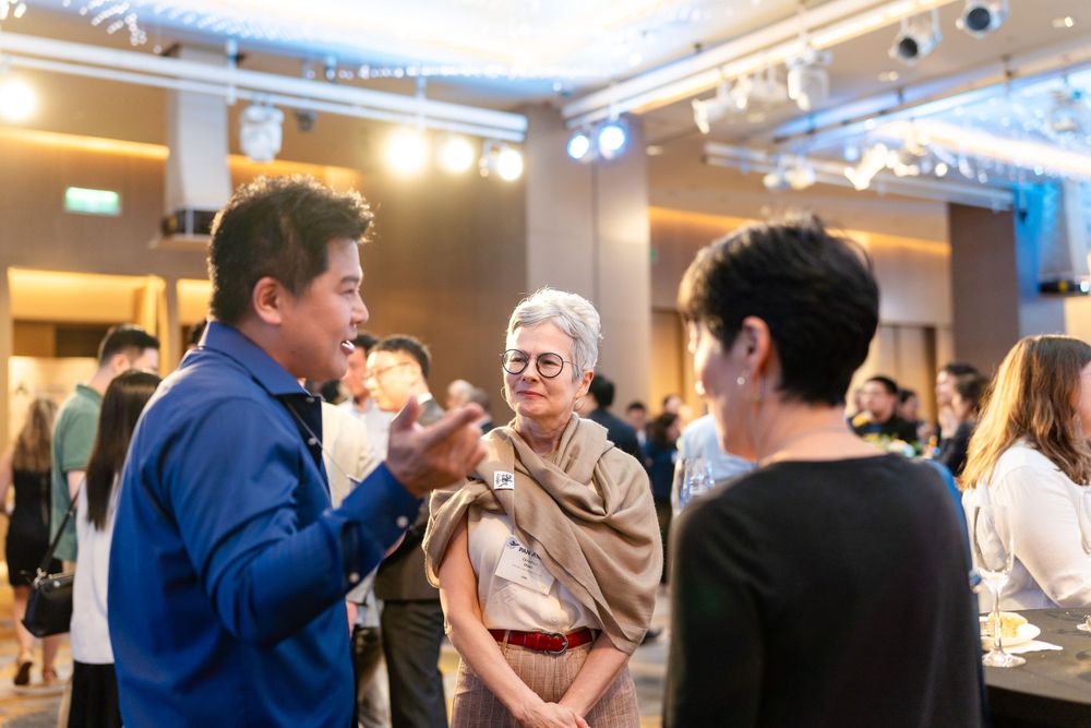 people chatting at alumni conference at Le Méridien Taipei