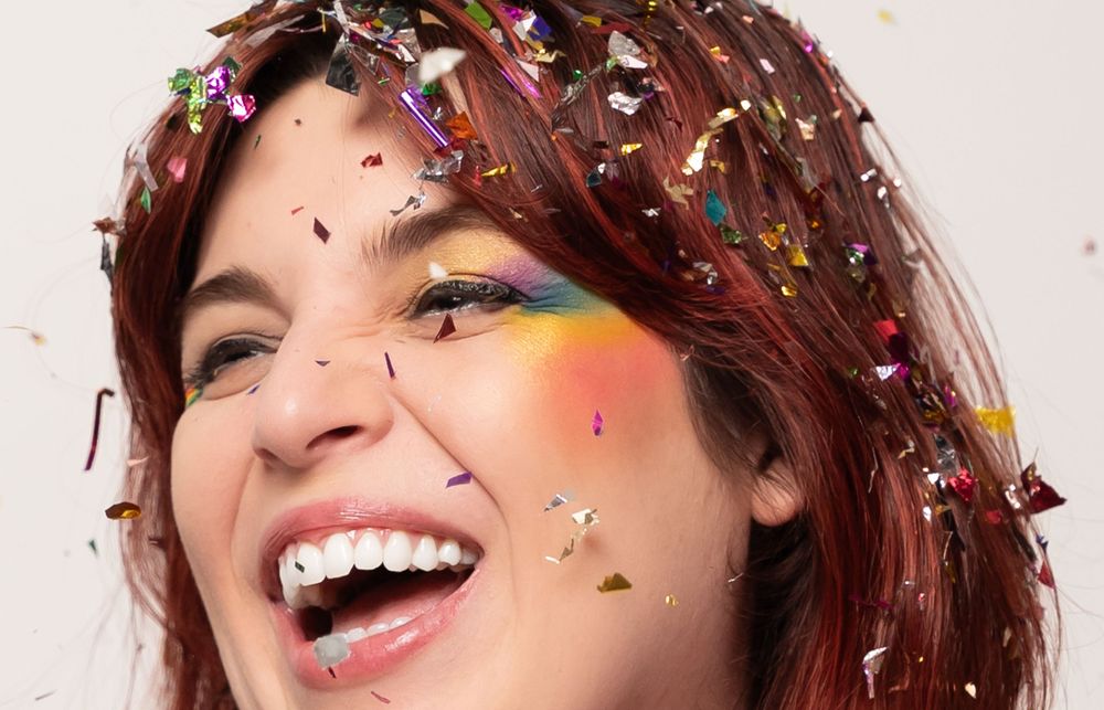 Close-up shot with sparkly confetti falling against a white backdrop.