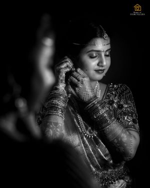Artistic black and white portrait showcasing traditional Indian bridal jewelry and henna.