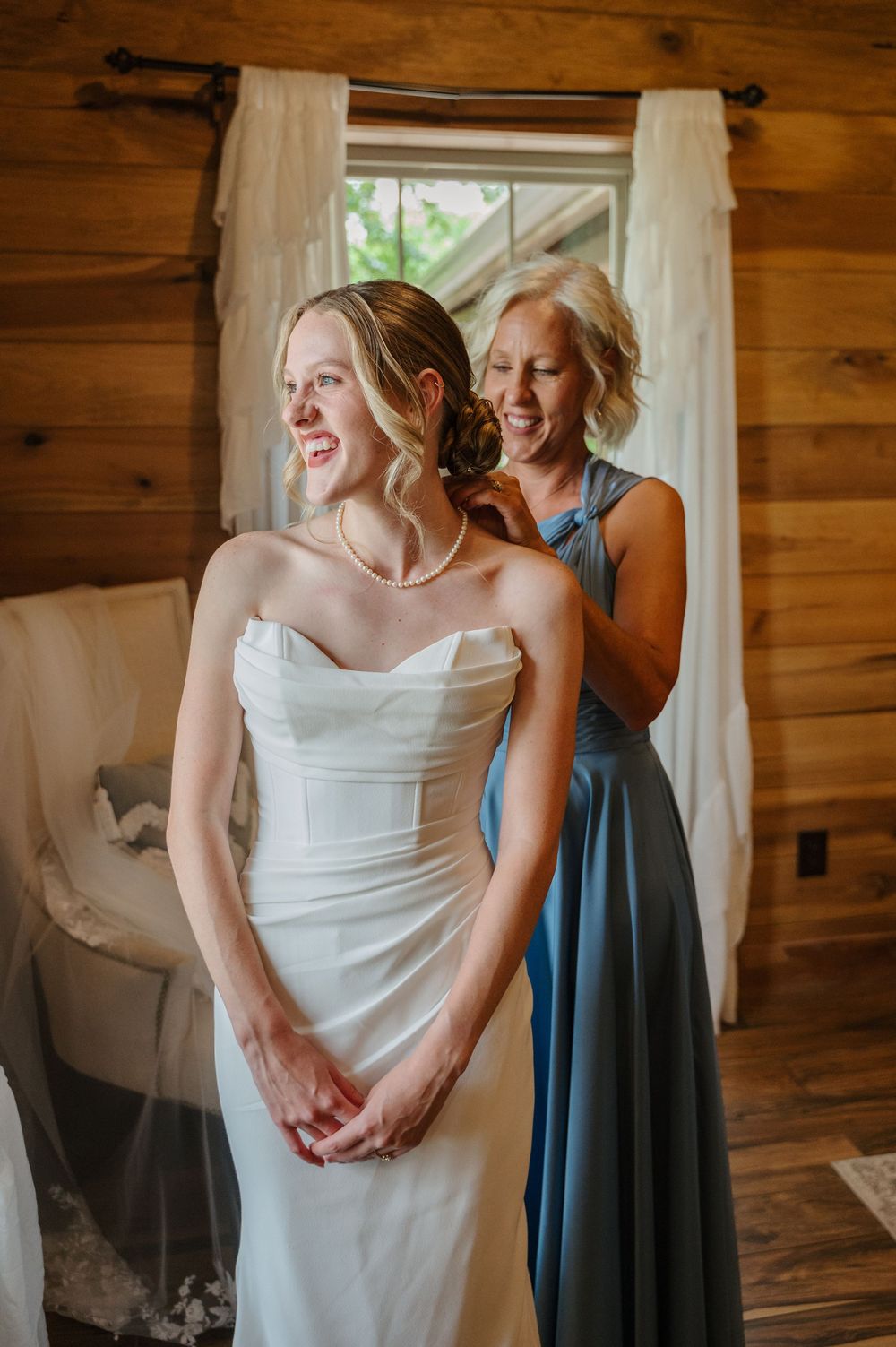 Mother of bride helping place the veil