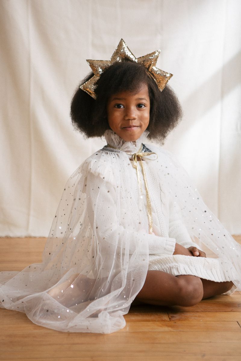 Joyful Holiday Studio Session: Candid Smiles of a Little Girl in a Tulle Cape and Star Headband