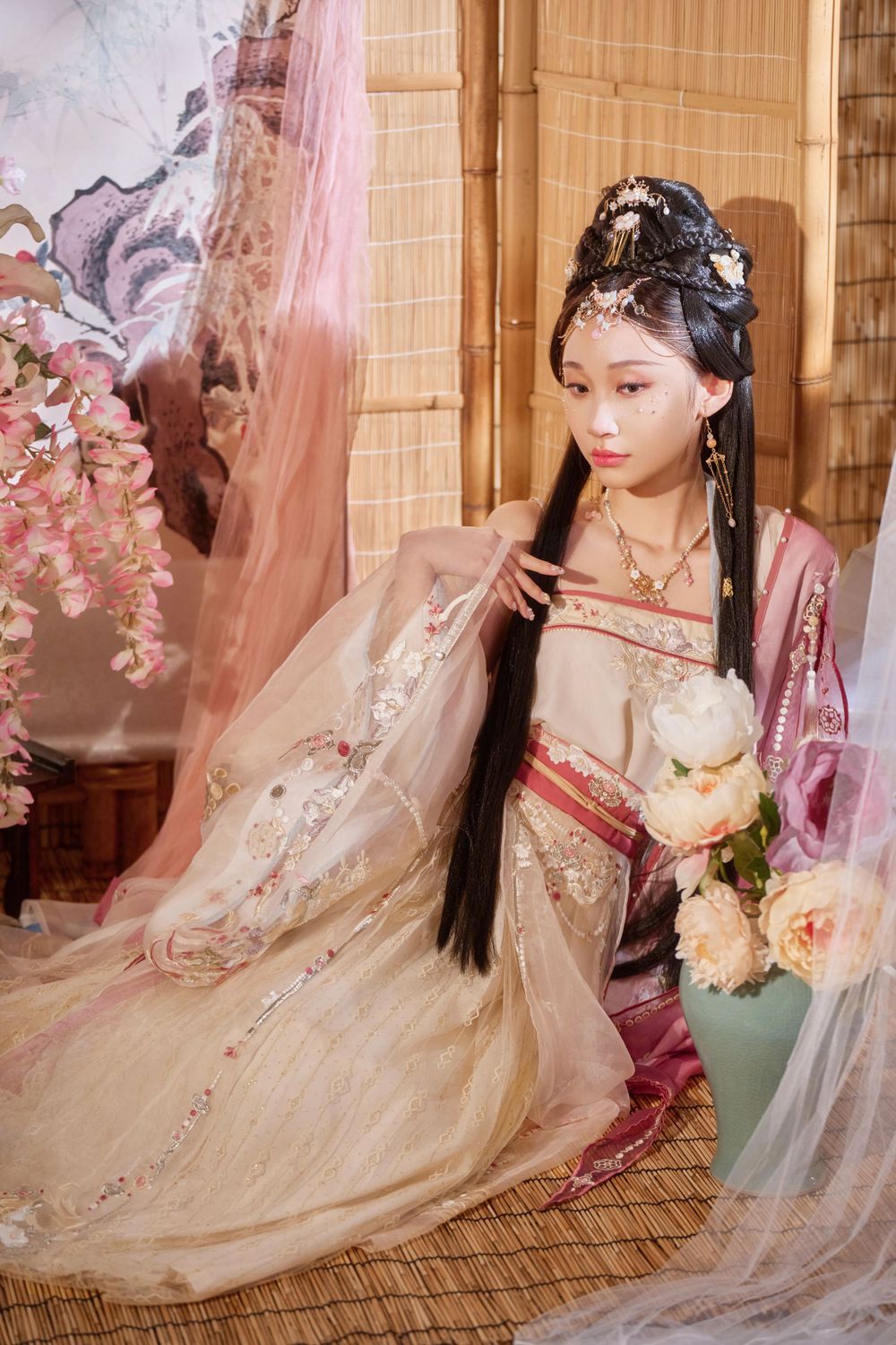 Glamorous pink Hanfu portrait featuring an amazing style, cold gaze, and light bamboo backdrop, captured by Imagine Image Studio.
