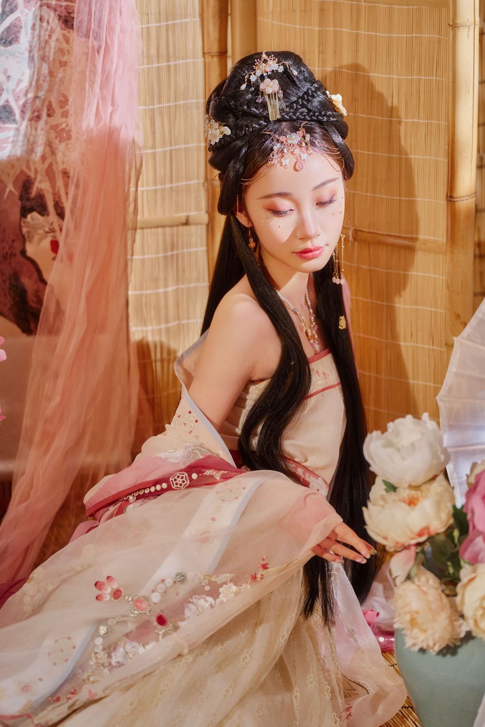 Glamorous pink Hanfu portrait featuring an amazing style, cold gaze, and light bamboo backdrop, captured by Imagine Image Studio.