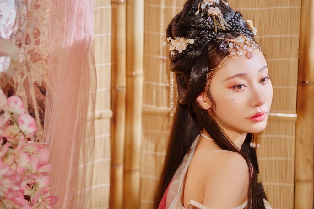 Glamorous pink Hanfu portrait featuring an amazing style, cold gaze, and light bamboo backdrop, captured by Imagine Image Studio.