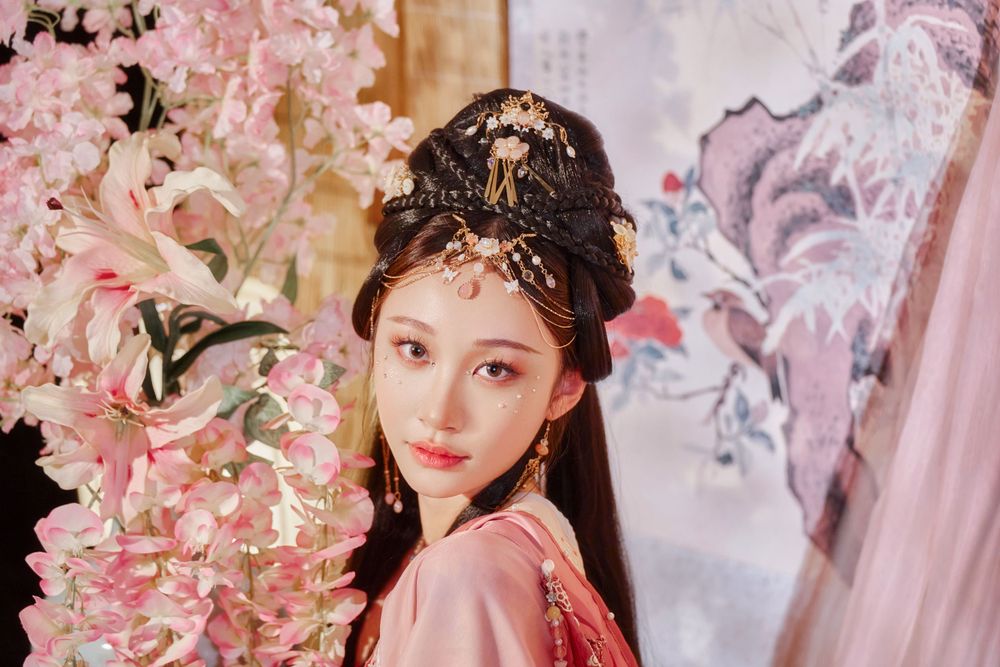 Glamorous pink Hanfu portrait featuring an amazing style, cold gaze, and light bamboo backdrop, captured by Imagine Image Studio.
