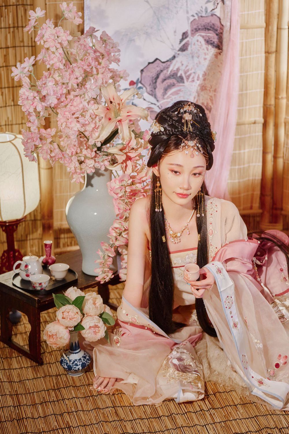 Glamorous pink Hanfu portrait featuring an amazing style, cold gaze, and light bamboo backdrop, captured by Imagine Image Studio.