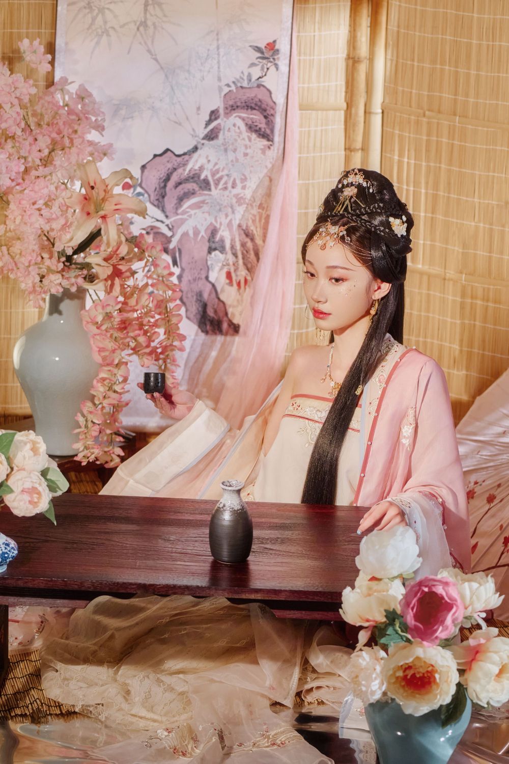 Glamorous pink Hanfu portrait featuring an amazing style, cold gaze, and light bamboo backdrop, captured by Imagine Image Studio.