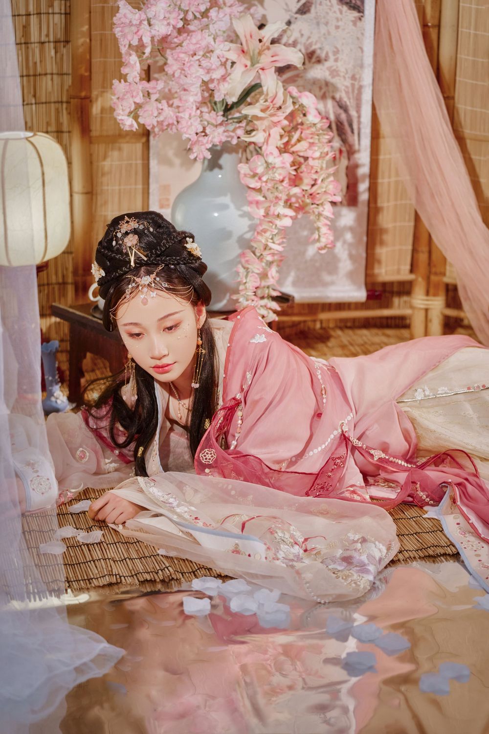 solo portrait in a gorgeous pink Han-element dress with a cold gaze against a light bamboo mat, by Imagine Image Studio.