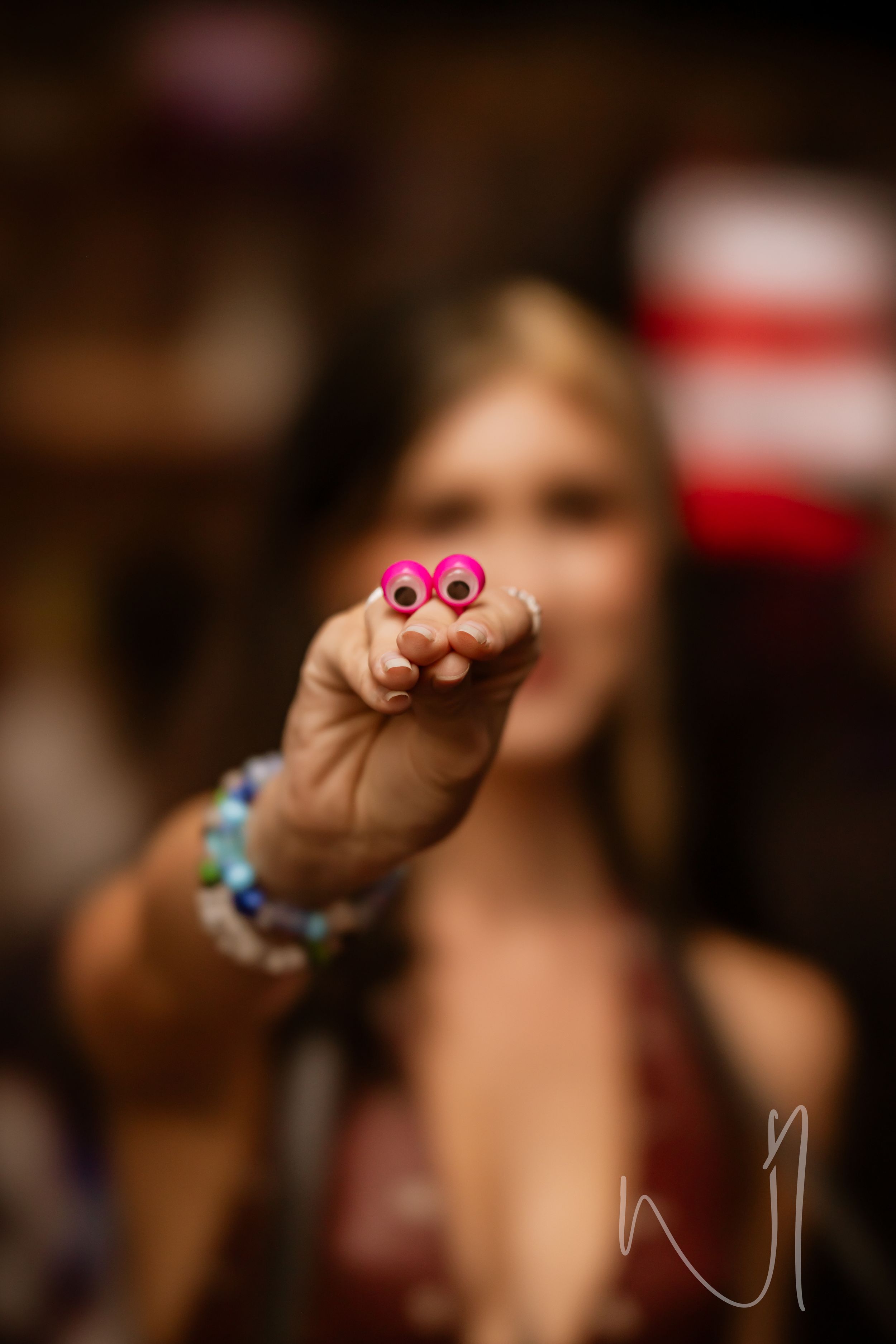 Macro close-up shot of colorful plastic toy rings displayed in a row against a dark blurred background.