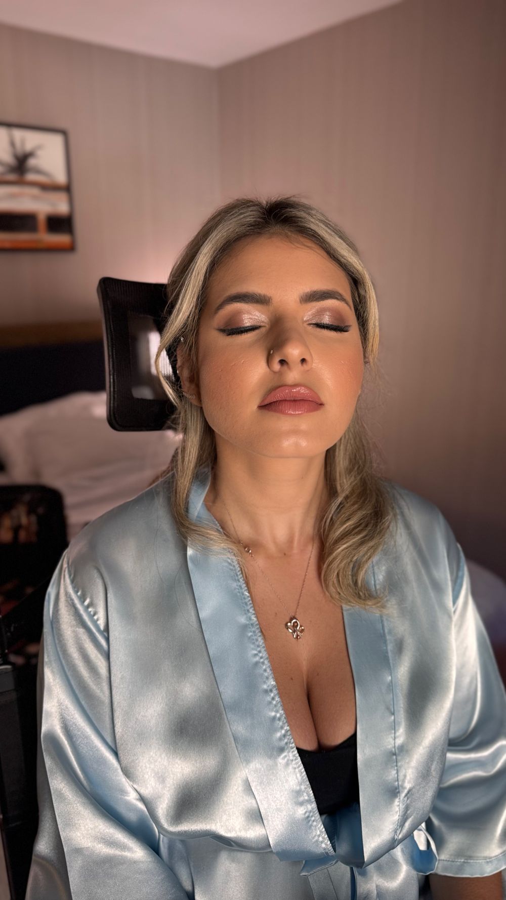 Person in light blue satin robe poses during getting ready photos.