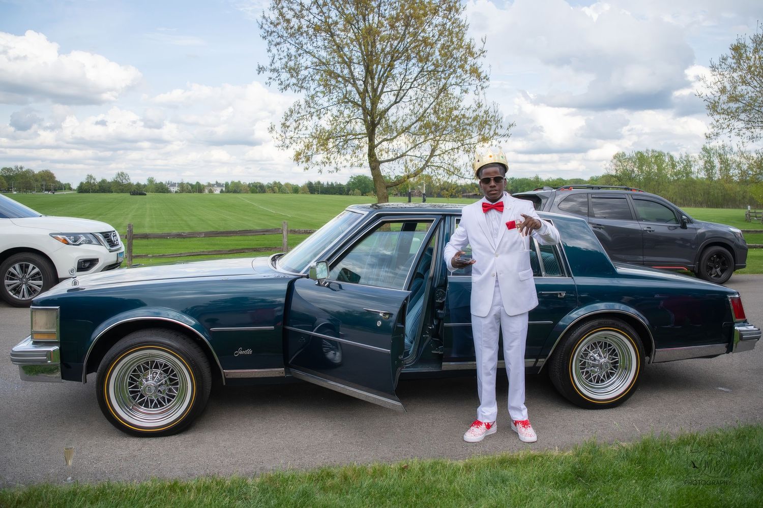 Classic vintage cars lined up outdoors for a formal event or celebration.