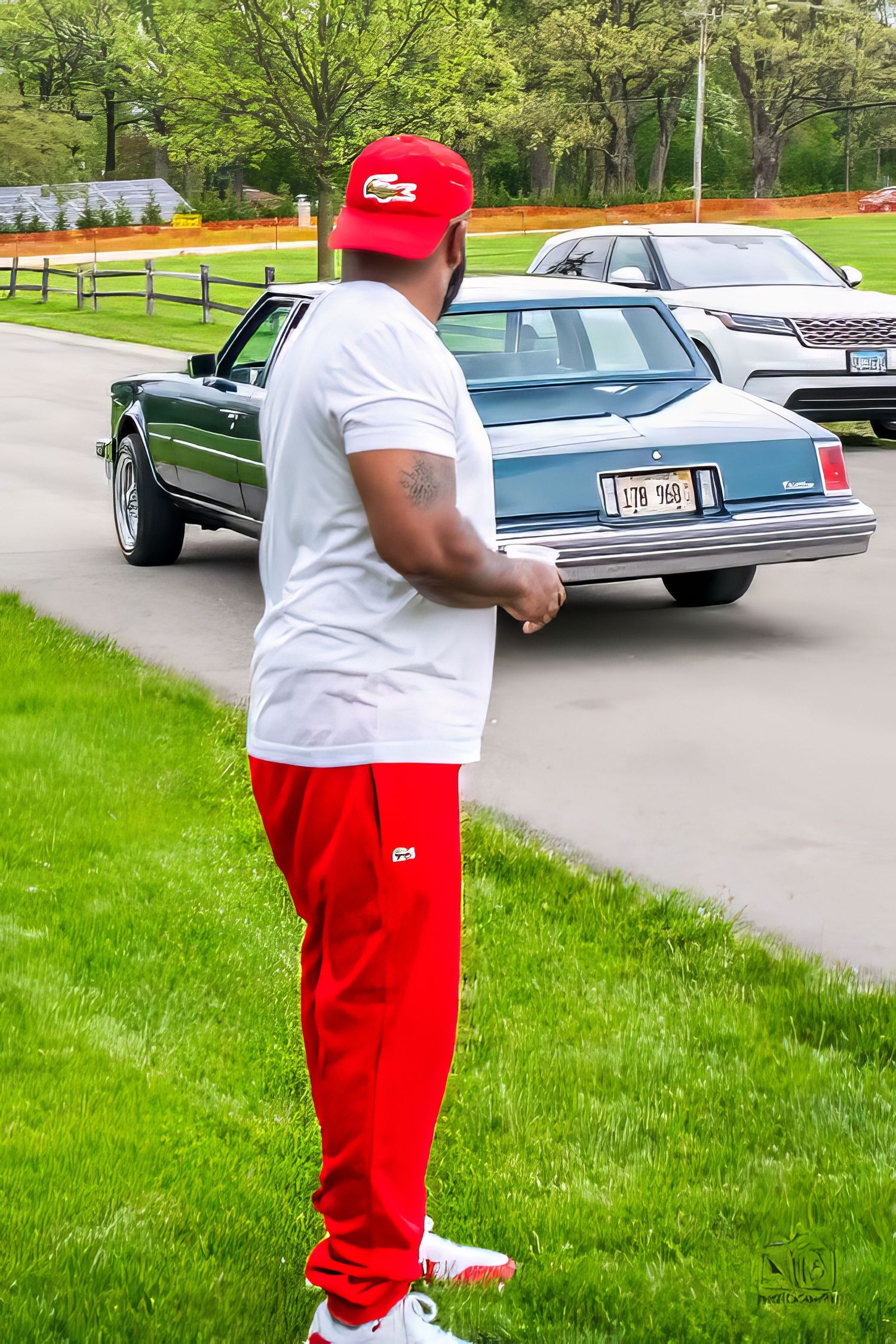 Four sequential photos show someone in red pants and white shirt standing next to classic cars parked on a street.