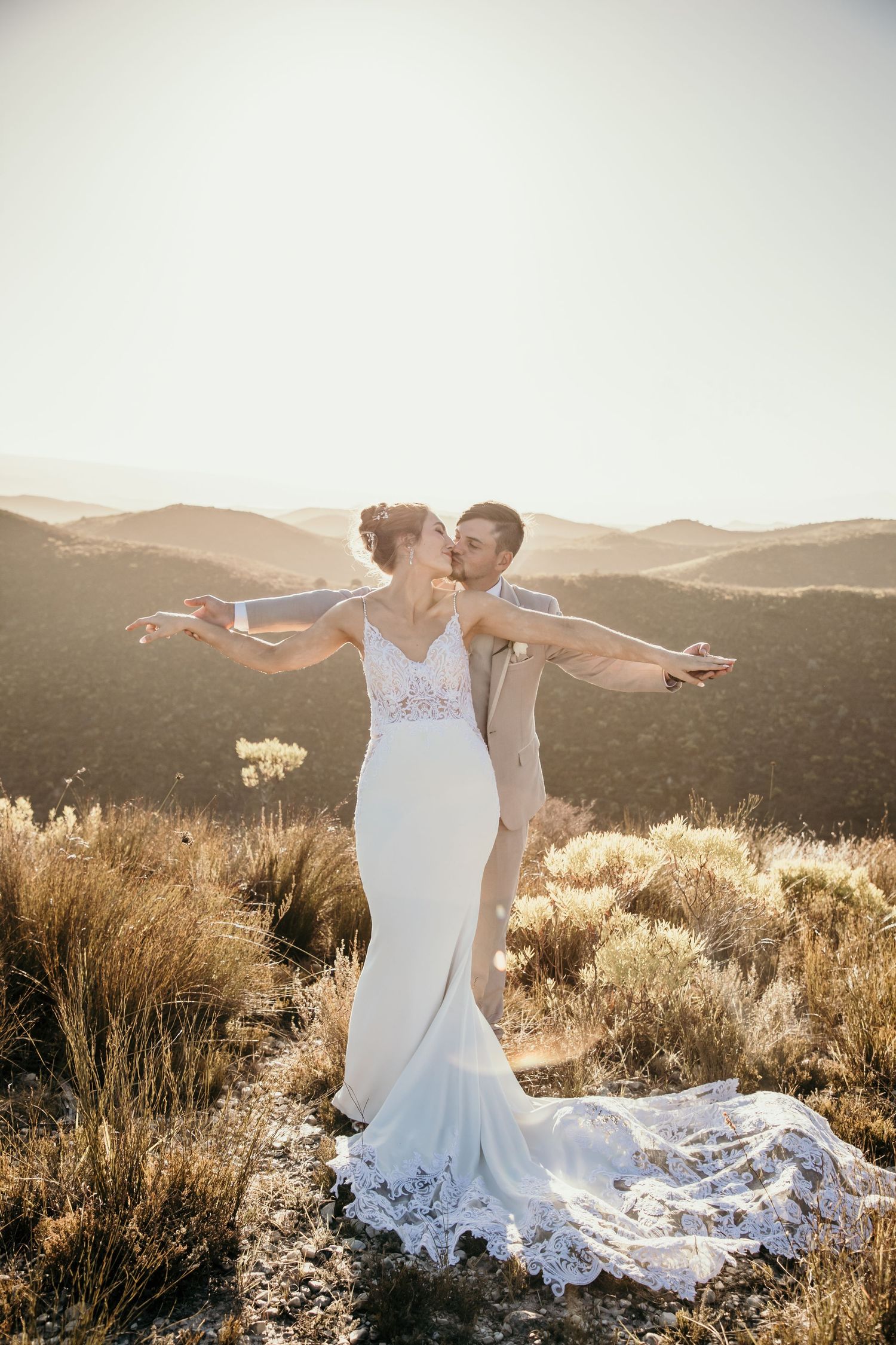 Bride and groom embracing during sunset wedding in Jeffreys Bay