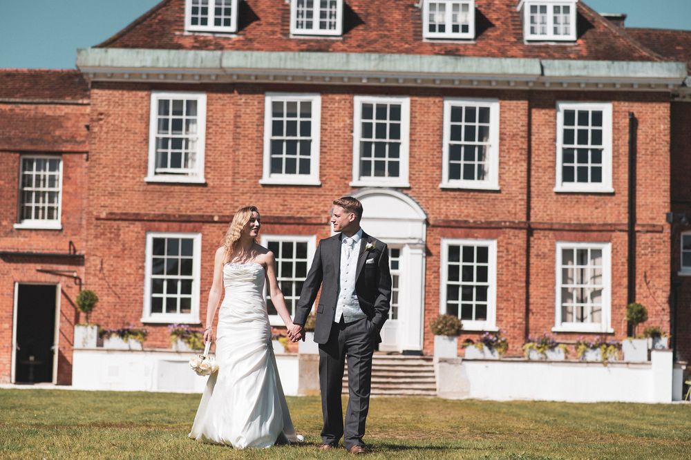 bride and groom outside manor house