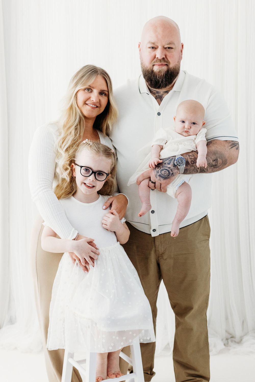 Natural family portrait in a minimal studio.