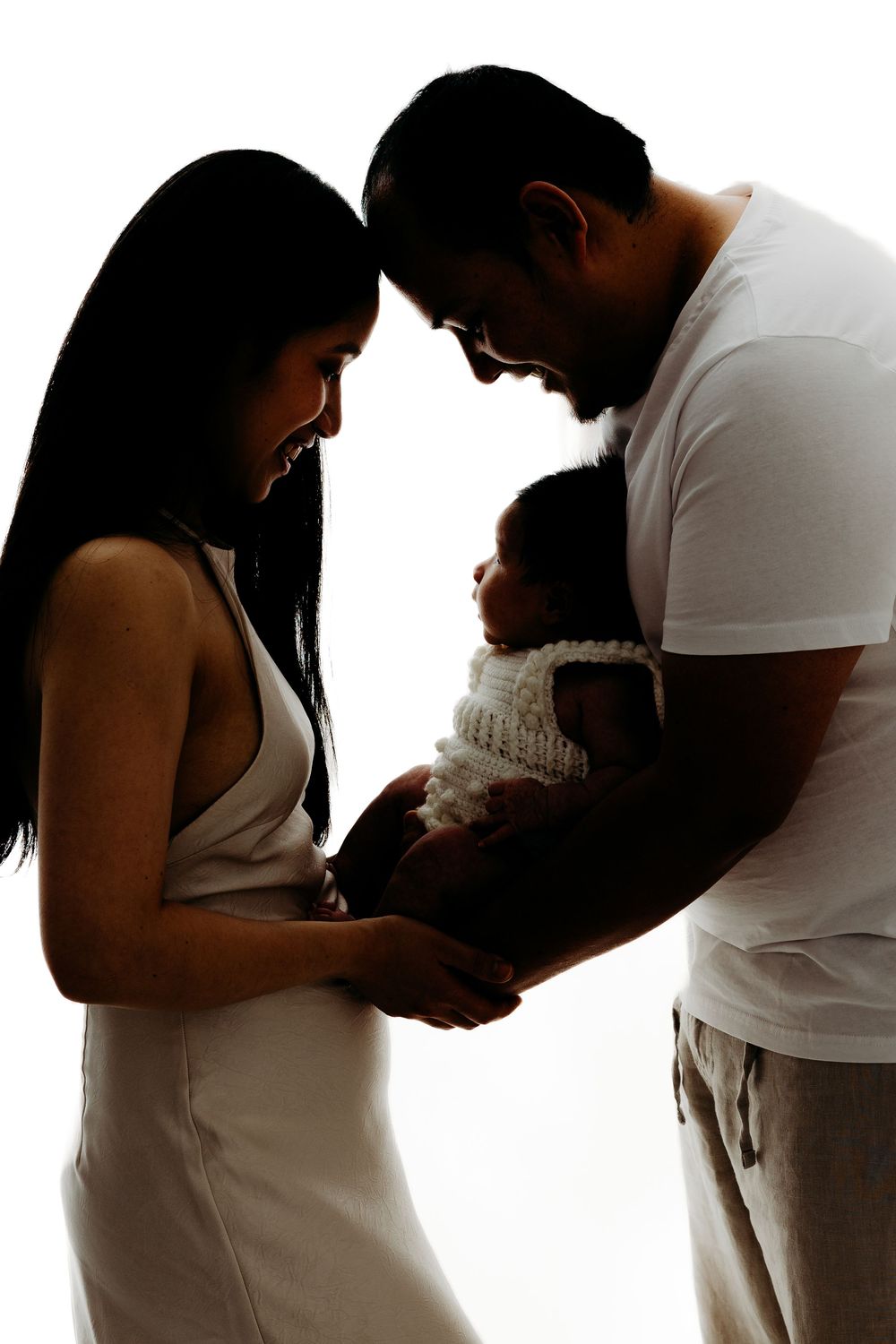 Family cuddling together during studio photography session.