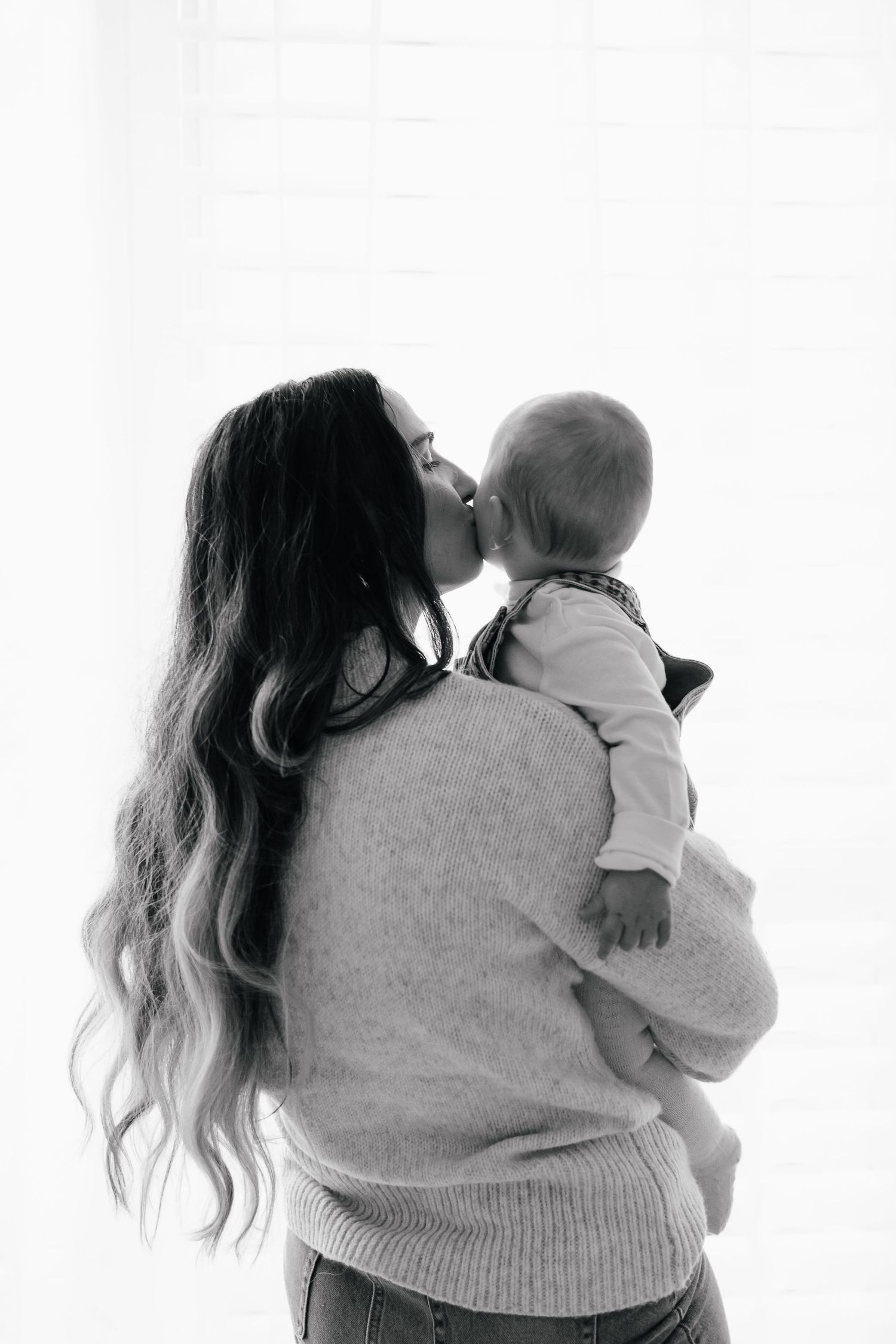 A tender moment captured between a parent and child sharing an affectionate nose kiss.