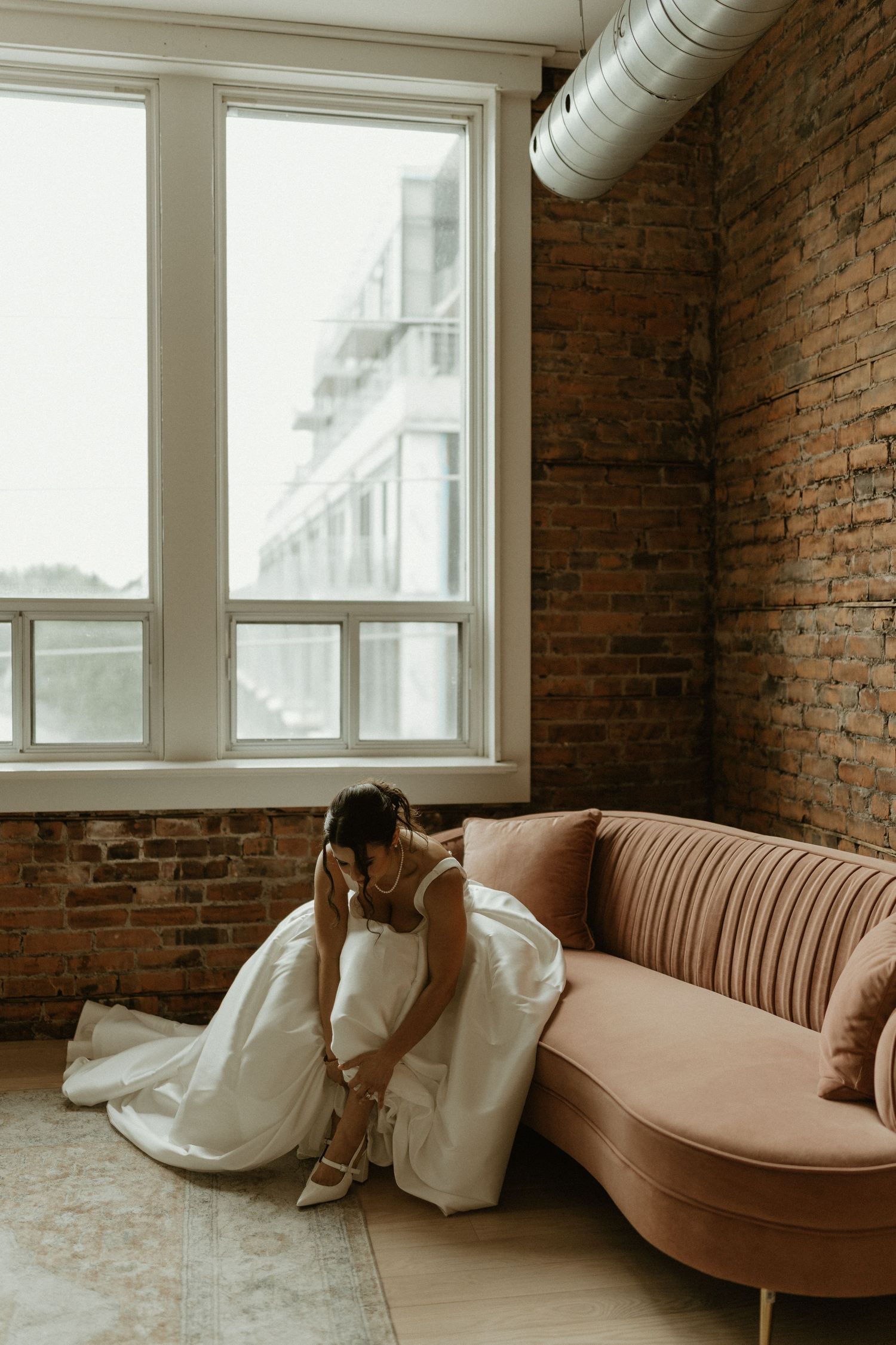 A bride is finishing her final touches before her wedding ceremony.